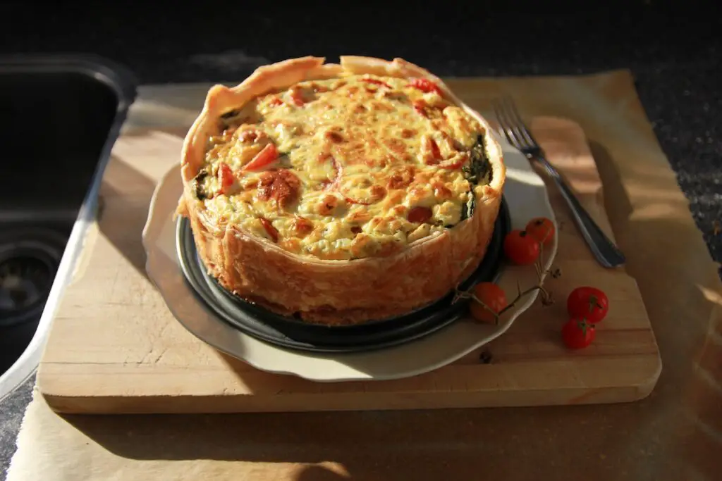 Quiche displayed on a chopping board. Credit: Unsplash
