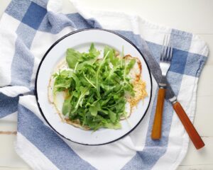 Fresh arugula salad on a plate. Credit: Unsplash