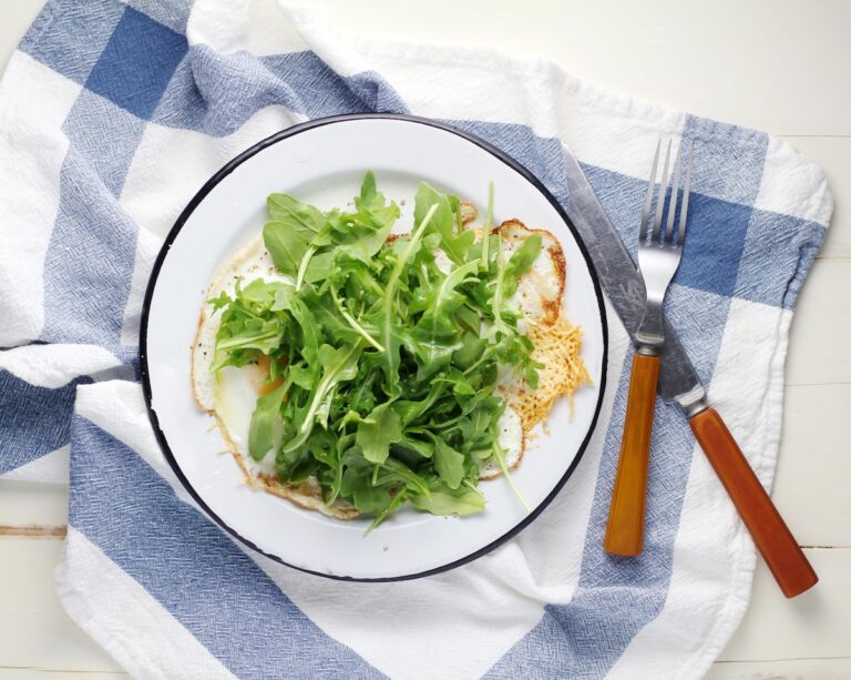 Fresh arugula salad on a plate. Credit: Unsplash