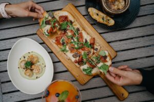 Sharing flatbread with friends. Credit: Unsplash