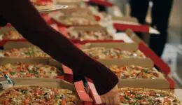 Pizzas on a table at a party. Credit: Unsplash