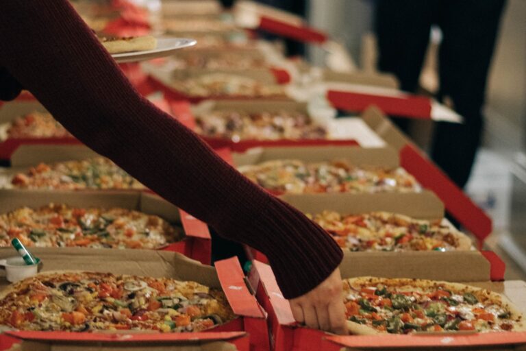 Pizzas on a table at a party. Credit: Unsplash