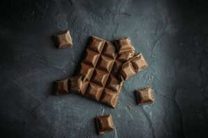 Chocolate broken up on a granite surface.