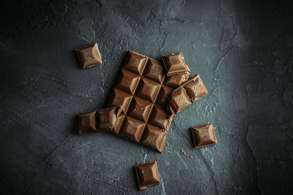 Chocolate broken up on a granite surface.