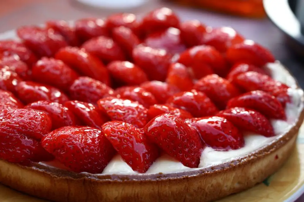 Cream based cheesecake with sliced strawberries and glazed.