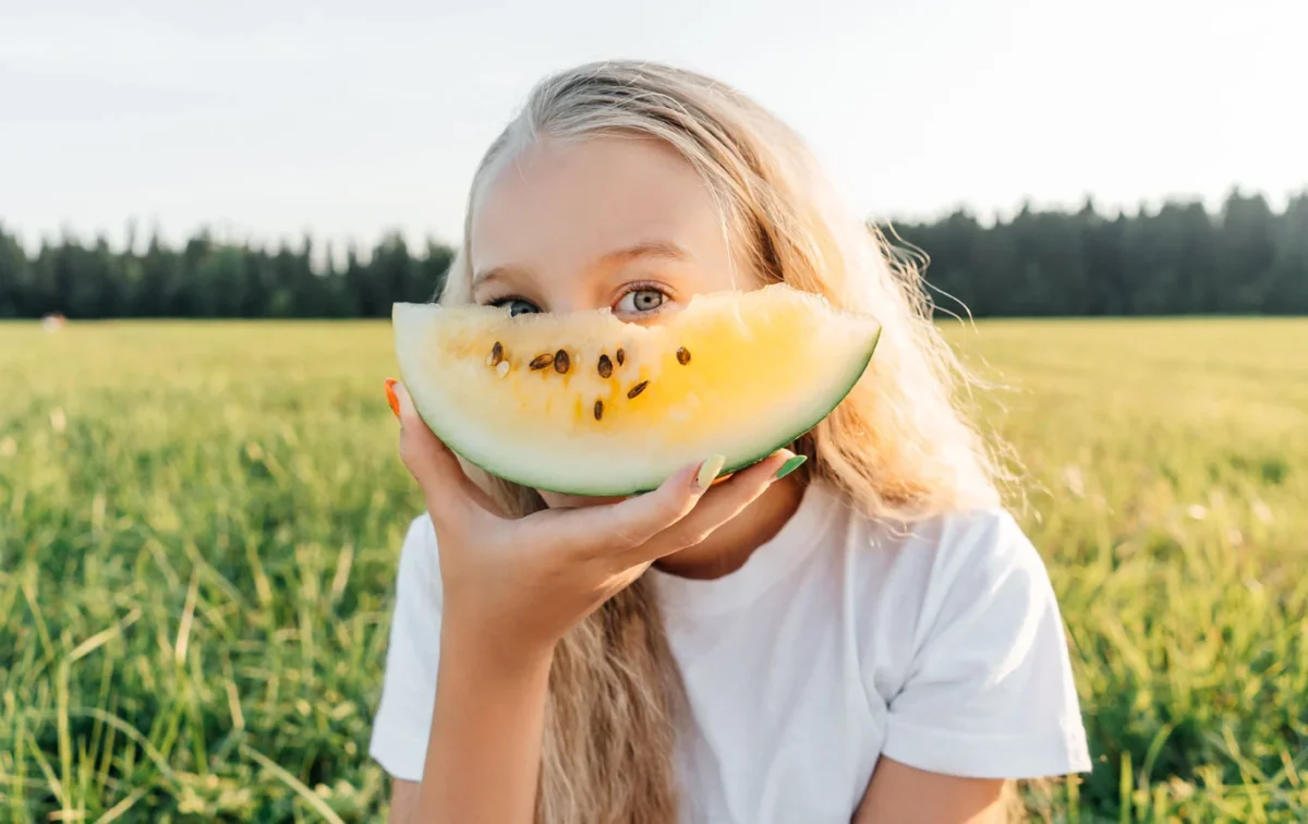 Girl with yellow watermelon. Credit: Nature of Home
