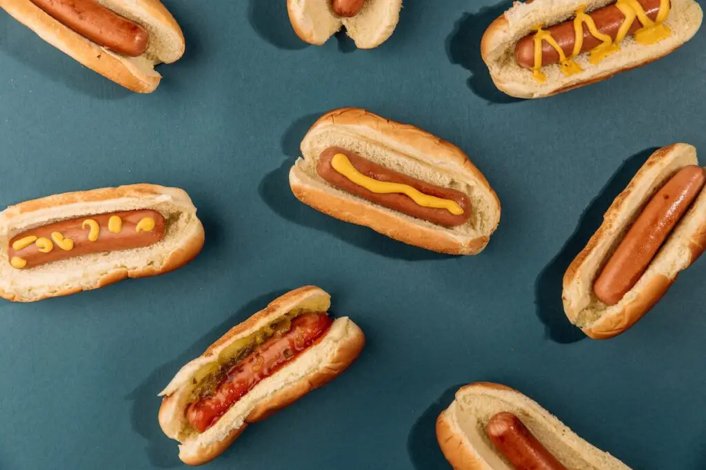 Different hot dogs with sauces and ingredients.