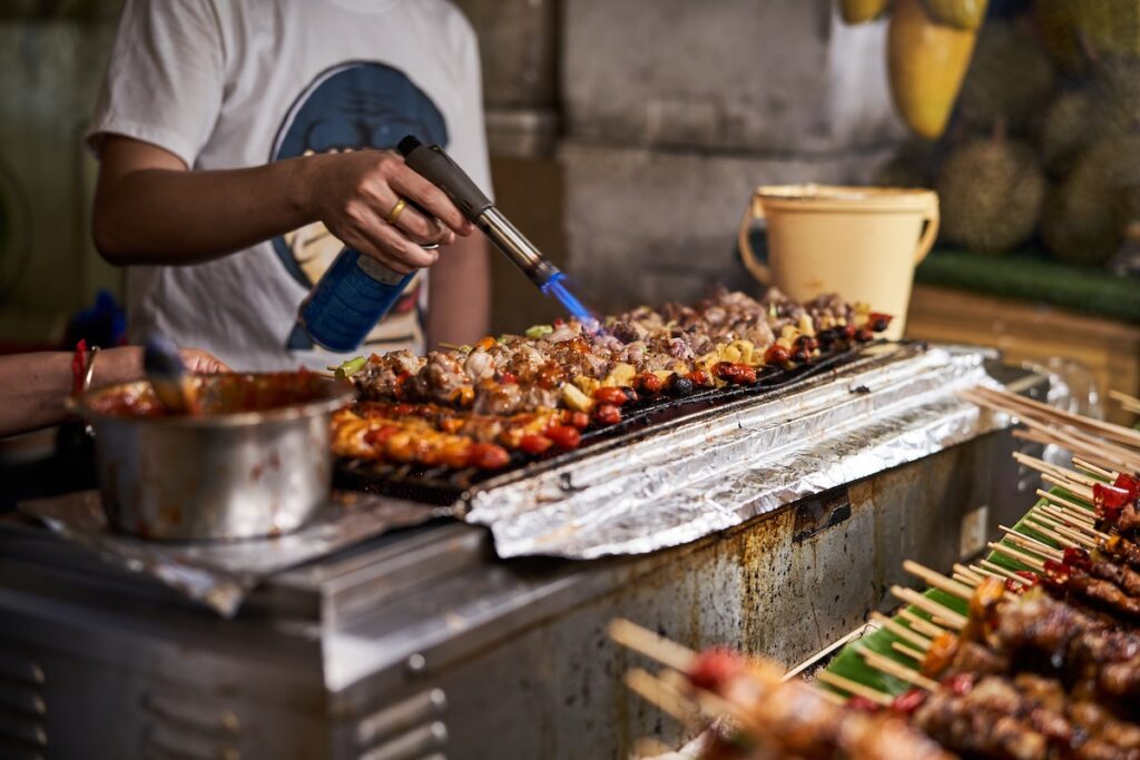 Thai BBQ Chicken being barbequed.