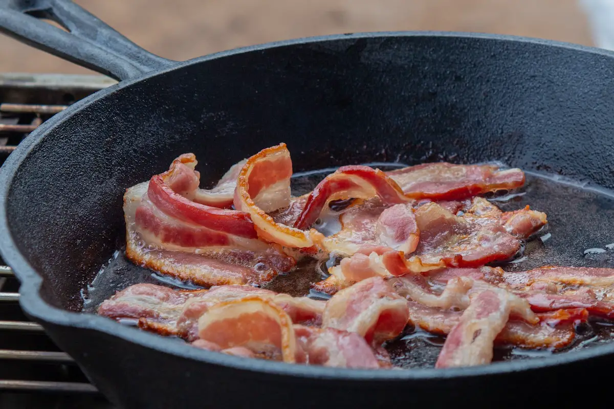 Bacon frying in a pan. Credit: Unsplash.
