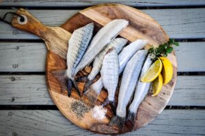 Headless fatty fish on a board.