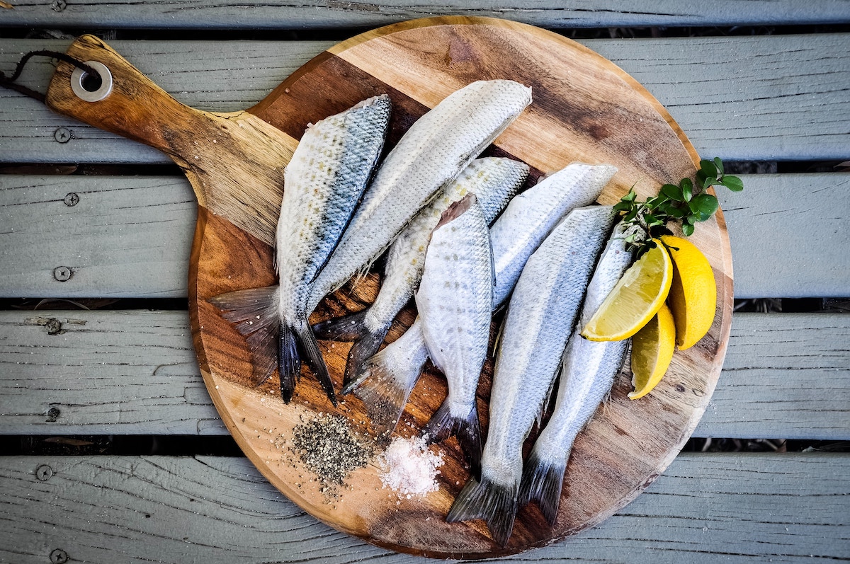 Headless fatty fish on a board.